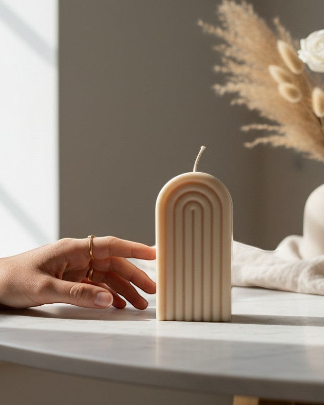 Luxora Candles Arcus decorative candle in a beige, arched, ribbed design. Modern, minimalist style.