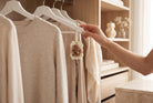 Luxora Candles floral wax wardrobe freshener hanging on a clothes hanger in a beige dressing room