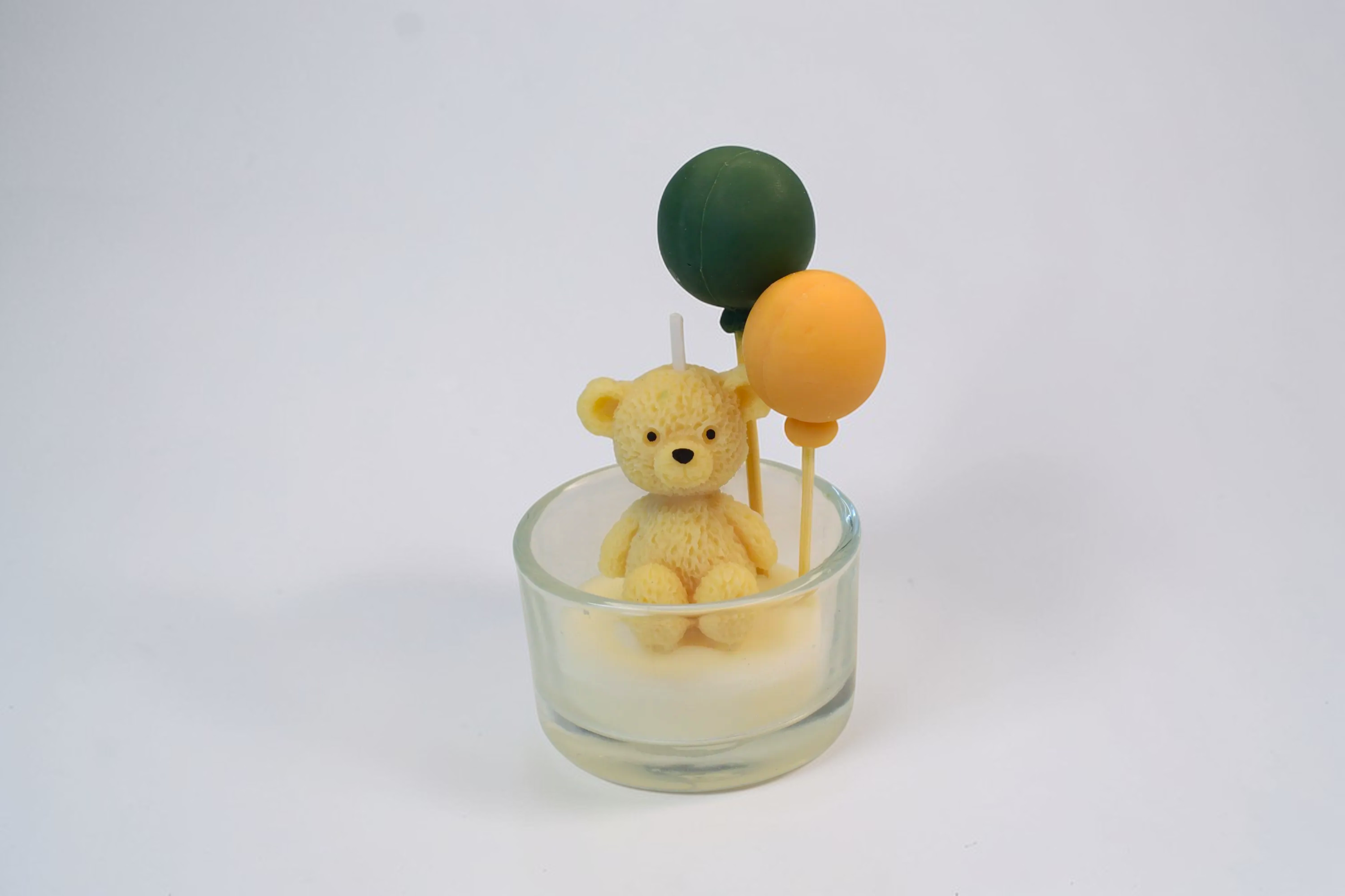 Luxora Candles handmade soy wax teddy bear candle with green and orange balloons, ideal for events.